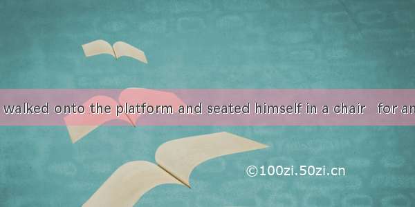 The professor walked onto the platform and seated himself in a chair   for answering quest